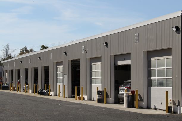 Auto body technicians refinishing a panel